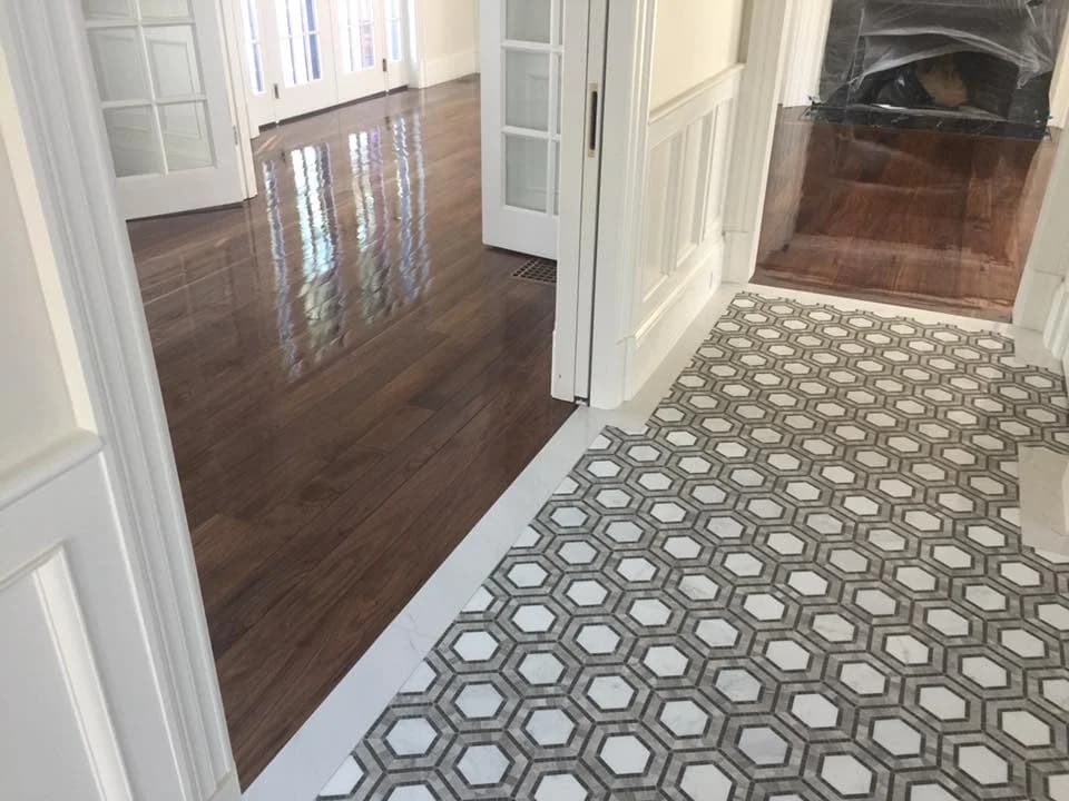 Custom hardwood installation, flush with tile work