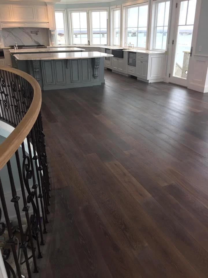 Dark, matte finish hardwood flooring in kitchen